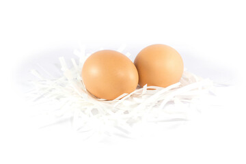 Fresh chicken eggs put on paper cut scrap isolated on white background.