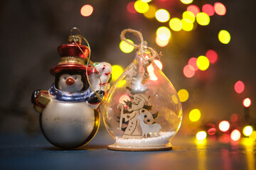 Christmas tree toys on a blue surface with a blurred background