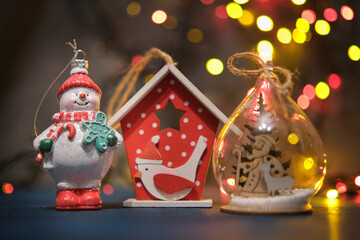 Christmas tree toys on a blue surface with a blurred background