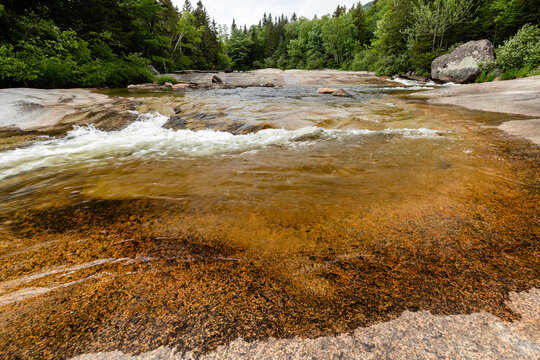 Water of Nesowadnehunk stream flows over the rocks of Ledge Falls in Baxter State Park, Maine
