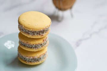 Traditional Argentinian alfajores with dulce de leche on marble table. Argentine gastronomy concept.