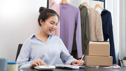 Live shopping concept a female seller counting a stock and checking a number of parcels before sending to customers by postal delivery