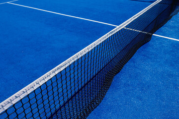 Net on a blue paddle tennis court