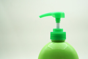 Green soap bottle with pump on white background                                                  