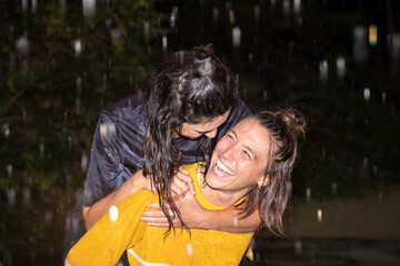 lesbian couple laughing in the rain