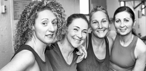 Happy four women at the gym, relaxing after workouts. Happiness and business concept