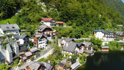 Fototapeta na wymiar Hallstatt, Austria. Aerial view of the beautiful town from a flying drone over the lake in summer season.