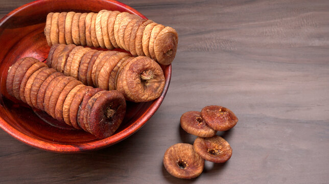 Fresh Figs or Anjeer fruit healthy vegan food concept organic dry fruits on wooden background.