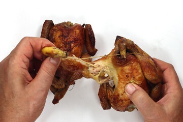Top view of a man's hands eating fried chicken