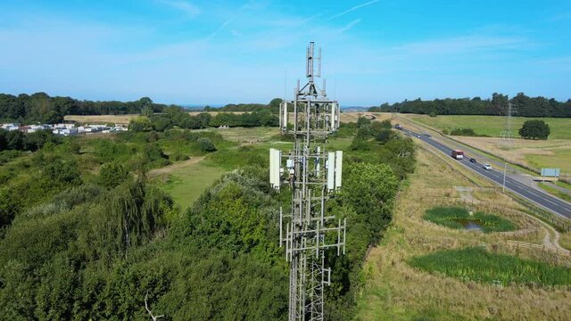 5G mast in countryside next to local road