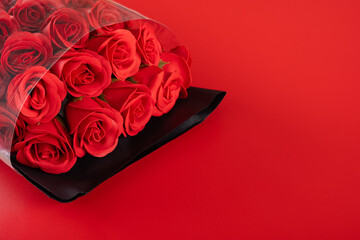bunch of roses on red background with copy space