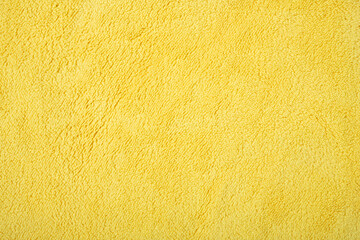 yellow fluffy cloth for cleaning as background and texture
