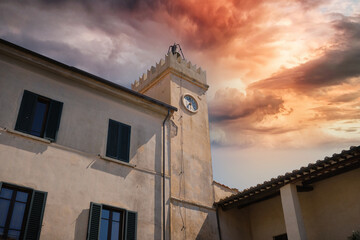 bell tower with clock in the village of Magliano in Tuscany