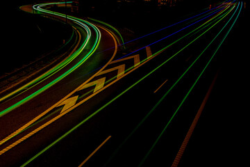 Fototapeta na wymiar Night road lights. Lights of moving cars at night. long exposure red, blue, orange, multicolored