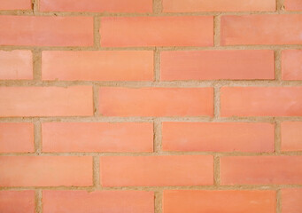 The brick wall of the fireplace is made of a red material, the seams of which are made of clay, and in some places cracks and damage are visible.