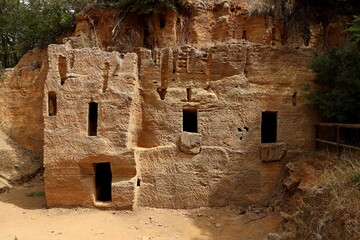 Chamber tombs carved into the rock in the Etruscan Necropolis of Populonia. Archaeological Park of Baratti and Populonia. Tuscany - Italy