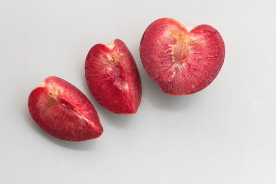 Cutted of Plumcot fruit with red pulp