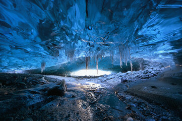 Photographer standing underground inside of a glacier, climate specific, vatnajokull National Park,...