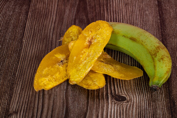 Banana chip or locally known as kerepek pisang with raw young banana. Selective focus points. Blurred background