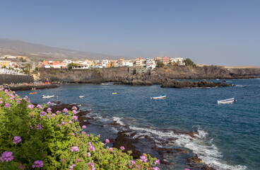 Fototapeta premium small village built on a rocky cliff by the blue sea on a summer day in the mediterranean sea