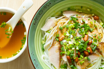 top view guilin rice noodles with bowl of soup nearby