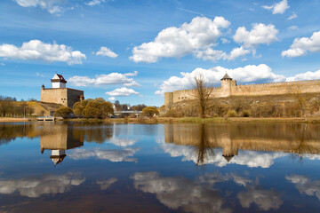 Fototapeta na wymiar Narva Herman castle and Ivangorod fortress stand on banks of Narva river. Medieval fortifications on Estonian-Russian state border