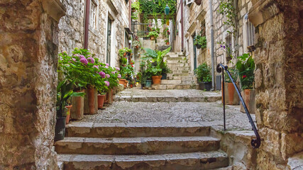 Mediterranean summer cityscape - view of a medieval street with stairs in the Old Town of Dubrovnik...