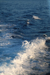 Sea foam and deep blue sea. Selective focus.