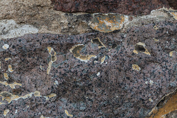 stone wall old plaster weathered and covered with moss