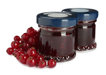 Jars with sweet jam and fresh berries on white background