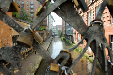 Love padlocks on a canal bridge in Manchester
