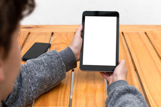 Person looking at a tablet in an upright position with space available