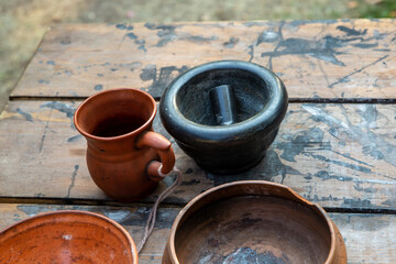 crockery jug earthenware mug and mortar on the table traditional