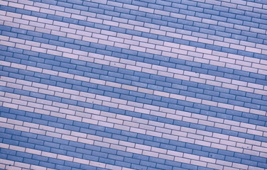 brick wall background blue, lilac and purple stripes oblique