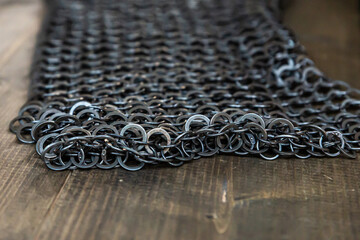 chain mail from rings part of protection on a wooden table close up