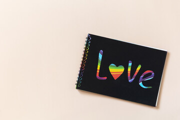 Mockup with Word love painted in rainbow paint LGBT. LGBTQ concept, for lesbian, gay, bisexual, transgender, and queer people. Concept of the Pride day, homosexual love, marriage, partnership sex.