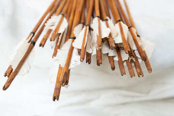 wooden boom support, white feather for balancing flight