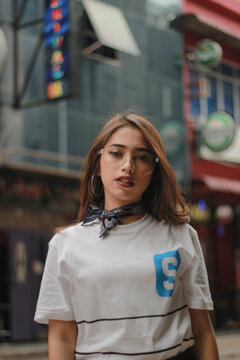 Portrait of young woman with eyeglasses outdoors