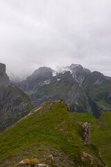 Fototapeta premium Amazing hiking day in the hearth of Switzerland. Wonderful scenery while climbing the summit and watching over the alps. Epic landscape.