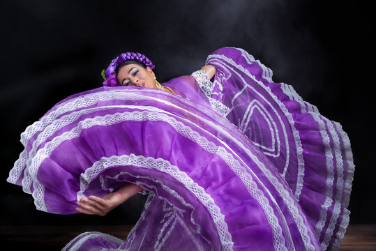 Woman in purple Chiapas dress dancing