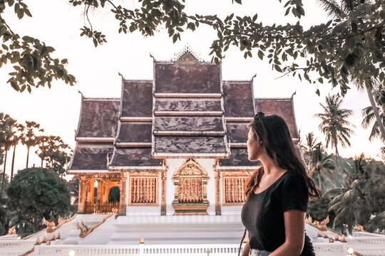 Woman looking at Haw Pha Bang, the Royal Chapel