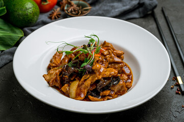 Sichuan Fried Pork, chinese cuisine on black stone table