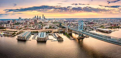 Aerial panorama with Ben Franklin Bridge and Philadelphia skyline at sunset. Ben Franklin Bridge is...