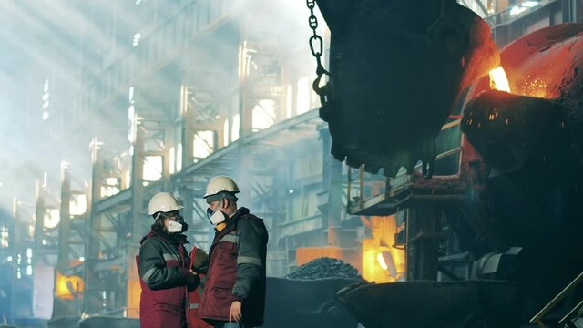 Steelworkers are observing and discussing foundry workshop