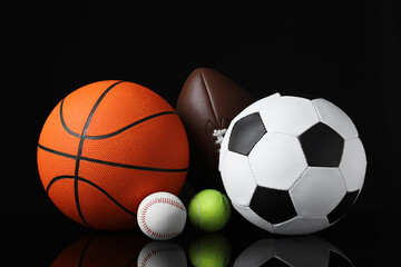 Set of different sport balls on black mirror surface