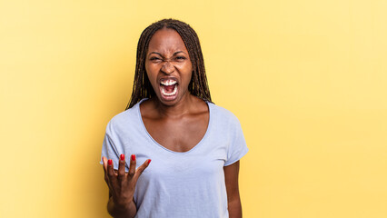 afro black pretty woman looking angry, annoyed and frustrated screaming wtf or what’s wrong with...