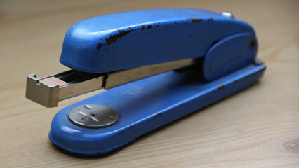 Closeup shot of a blue stapler - obrazy, fototapety, plakaty