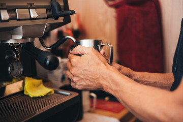 a barista preparing a cappuccino with a coffee machine