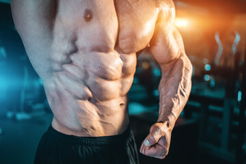 closeup of muscular bodybuilder man with perfect body have workout in gym