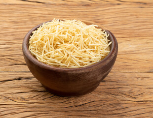 Potato straw or shoestring potato in a bowl over wooden table - obrazy, fototapety, plakaty